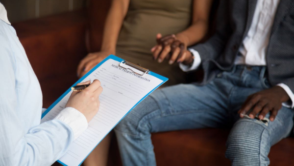 Couple holding hands and discussing infertility with North Houston fertility doctor